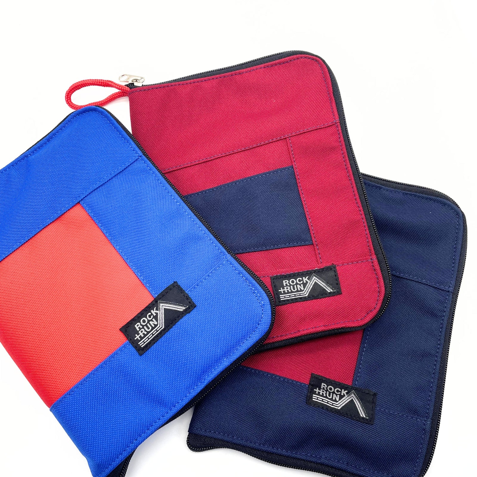 Three pouches in red, blue, and a combination of both with 'Rock & Run' branding on a white background.