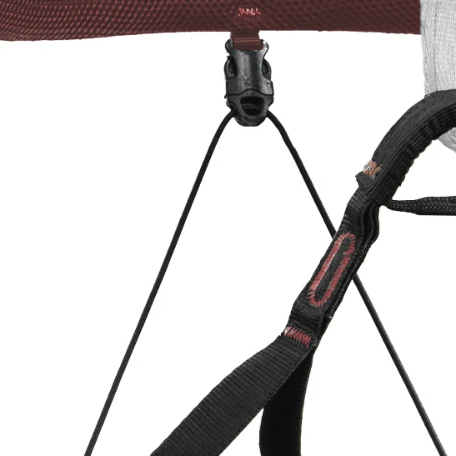 Climbing harness with brown and teal straps on a white background