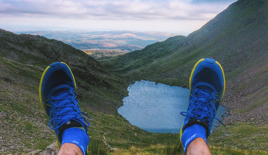 View of a lake and valley from runner wearing the Scarpa Spin running shoes