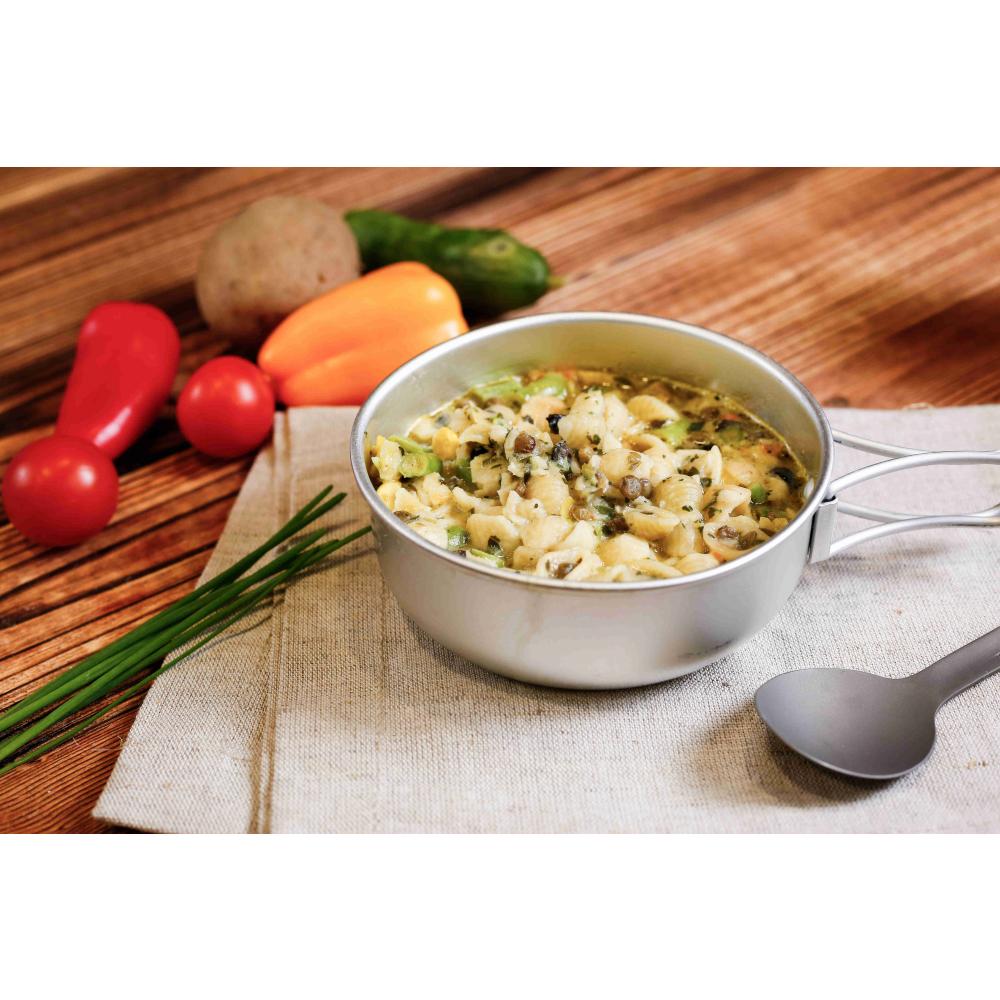 Expedition Foods Mediterranean Vegetable Pasta shown in bowl next to fresh ingredients and a spoon