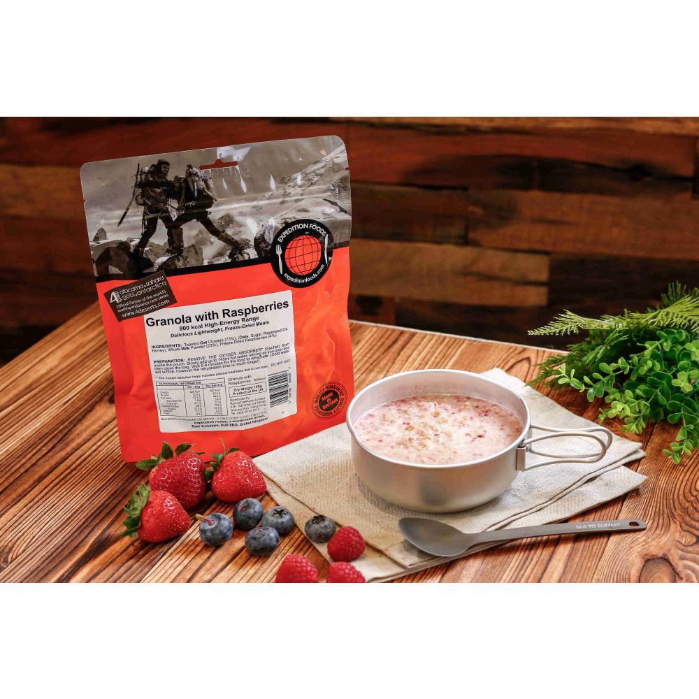 Expedition Foods Granola with Raspberries (800kcal) pack, shown next to food in a bowl on a table