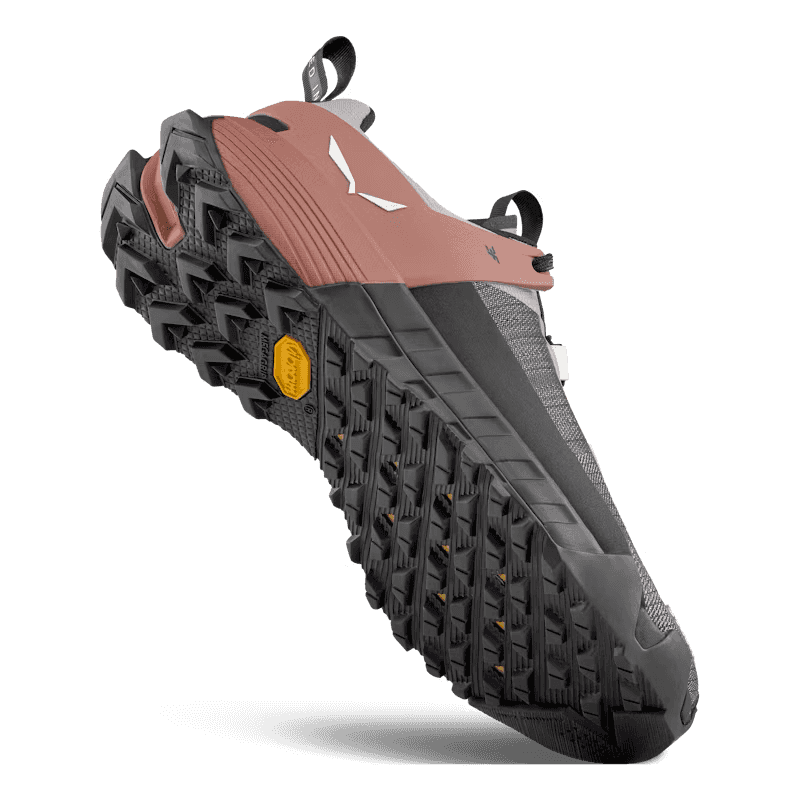 Close-up of a hiking shoe with a focus on the sole and tread pattern.