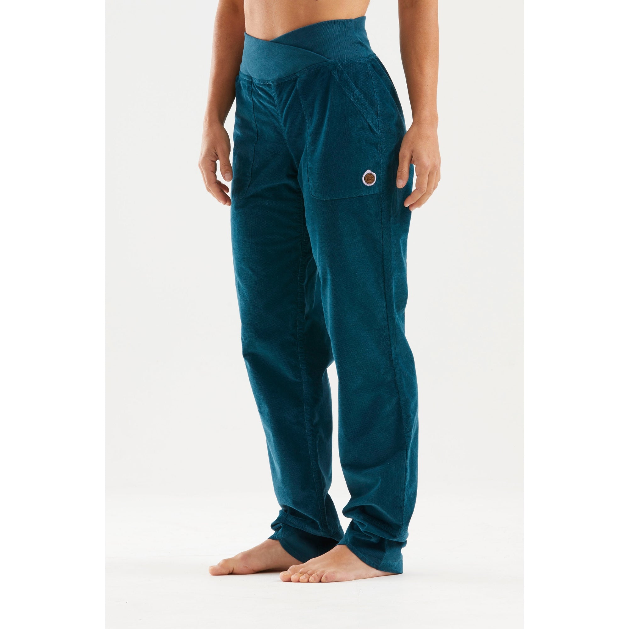 Teal pants worn by a person on a white background