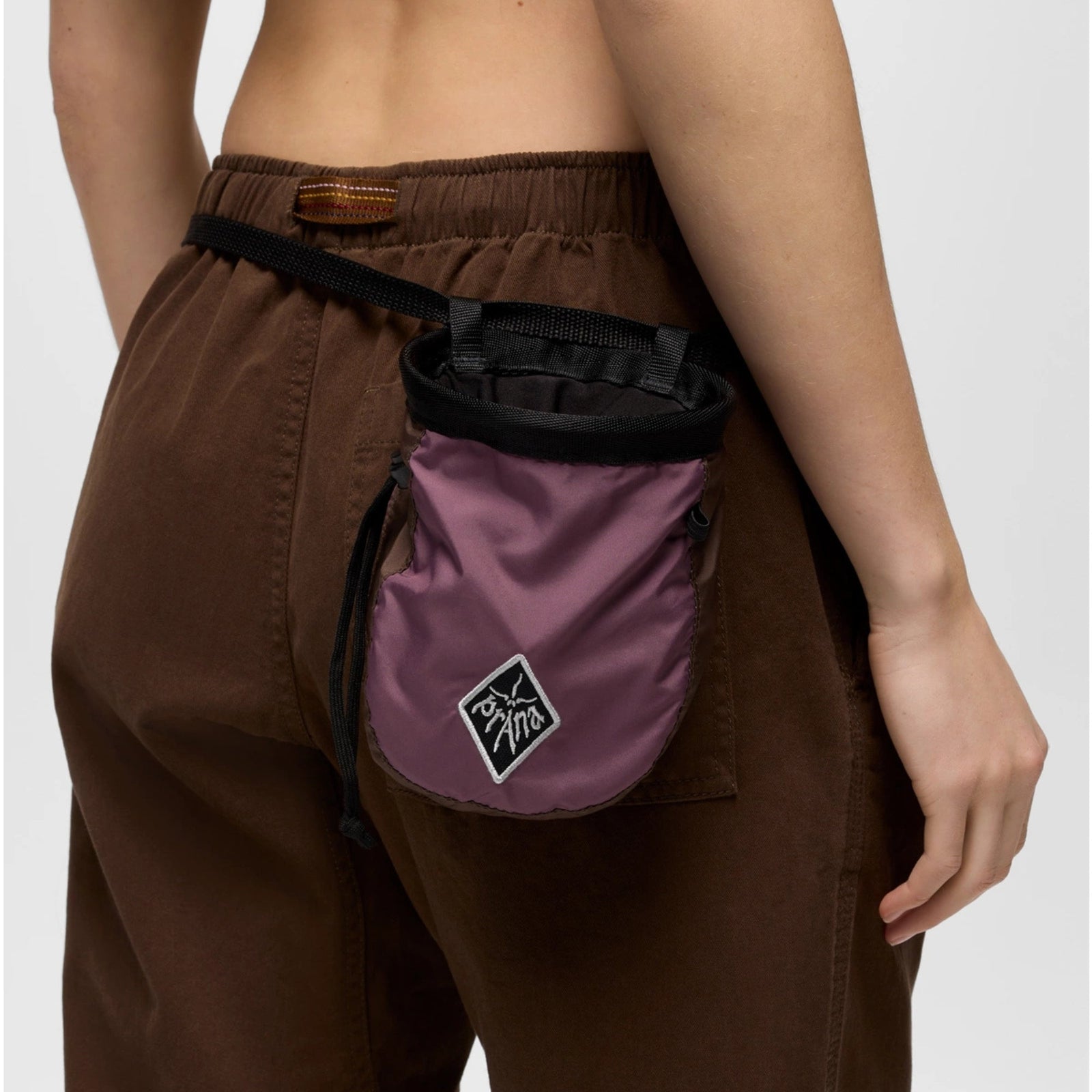 Purple and brown chalk bag with a logo on a white background