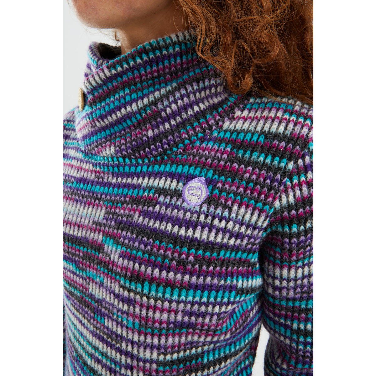 Multicolored knit sweater with a brand logo on a white background