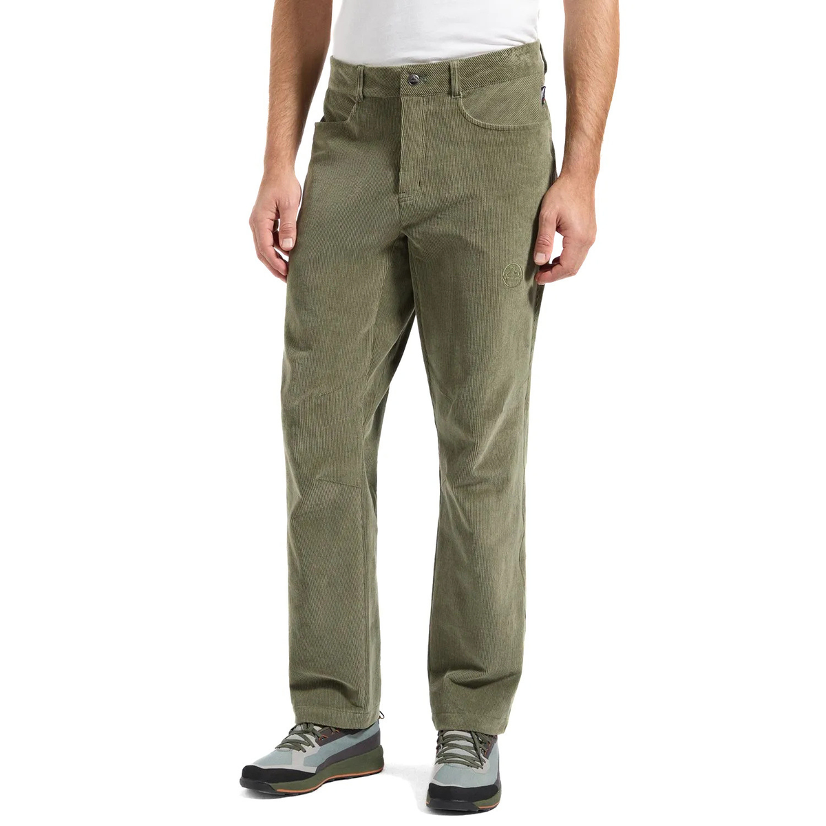 A person wearing olive green corduroy pants, a white t-shirt, and gray hiking shoes, shown from the waist down on a white studio background.