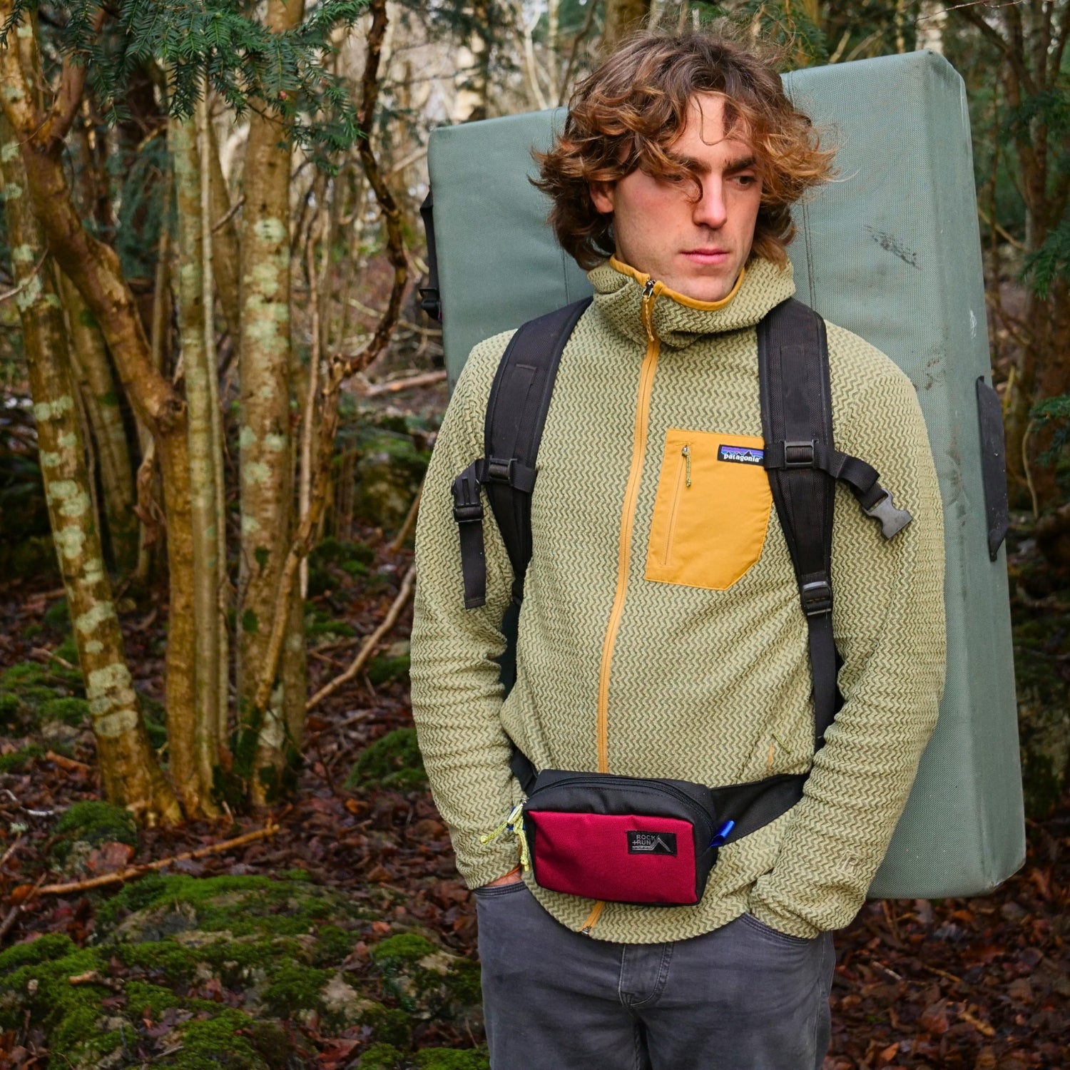 Rock+Run Drone Pack travel waist pack in blue and black with front zip pocket, ideal for carrying travel essentials like passport and phone