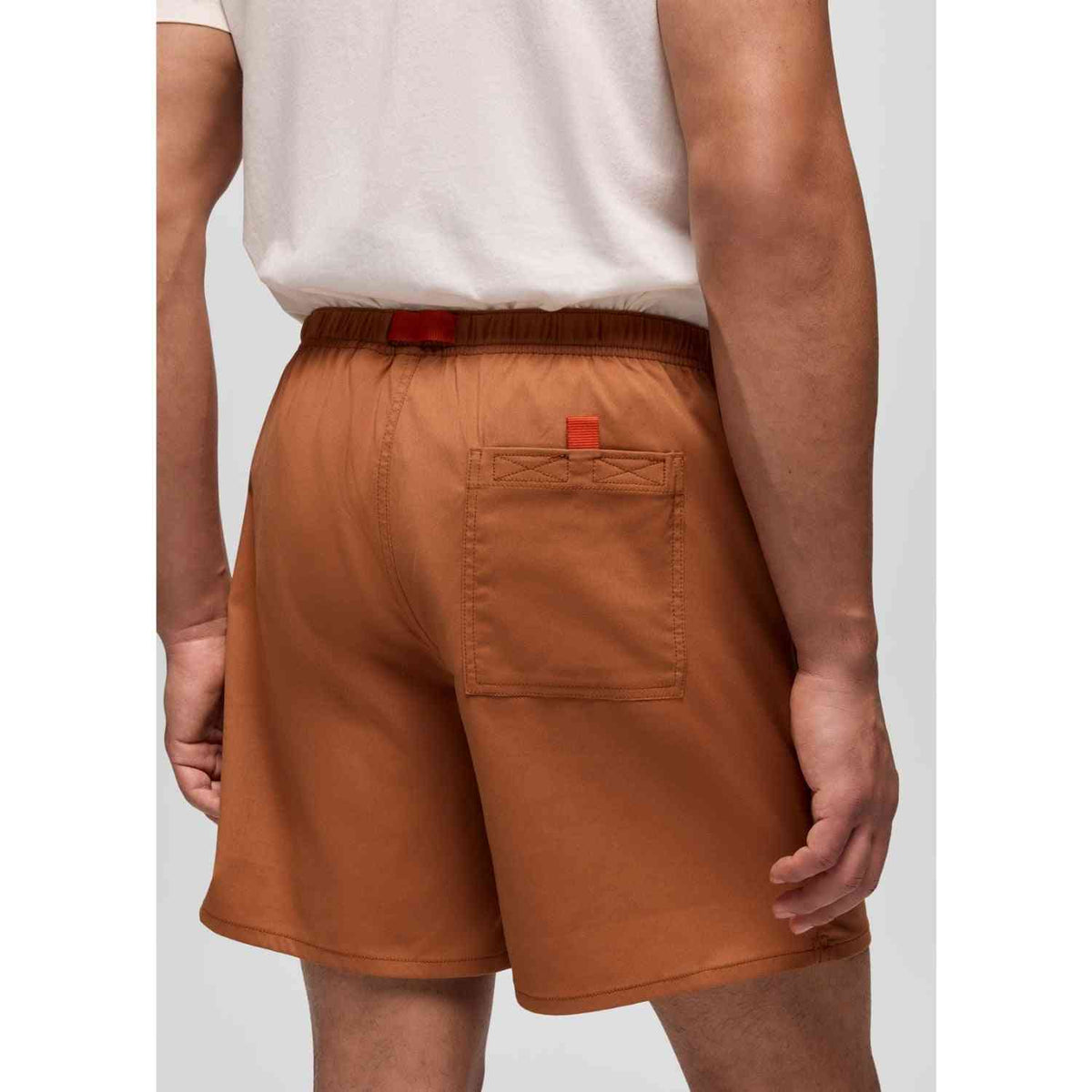 Prana Stretch Shorts for Men in rust color with back pocket and elastic waistband, ideal for outdoor comfort and mobility.