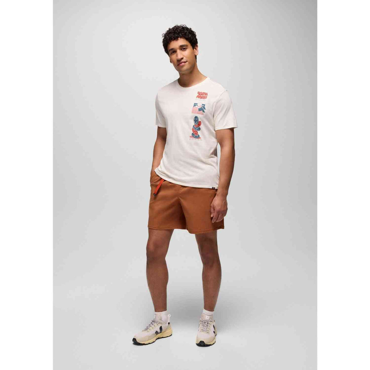 Prana Stretch Shorts for Men in rust color with pull-on waistband, shown worn with casual tee and sneakers. Ideal for outdoor comfort and mobility.