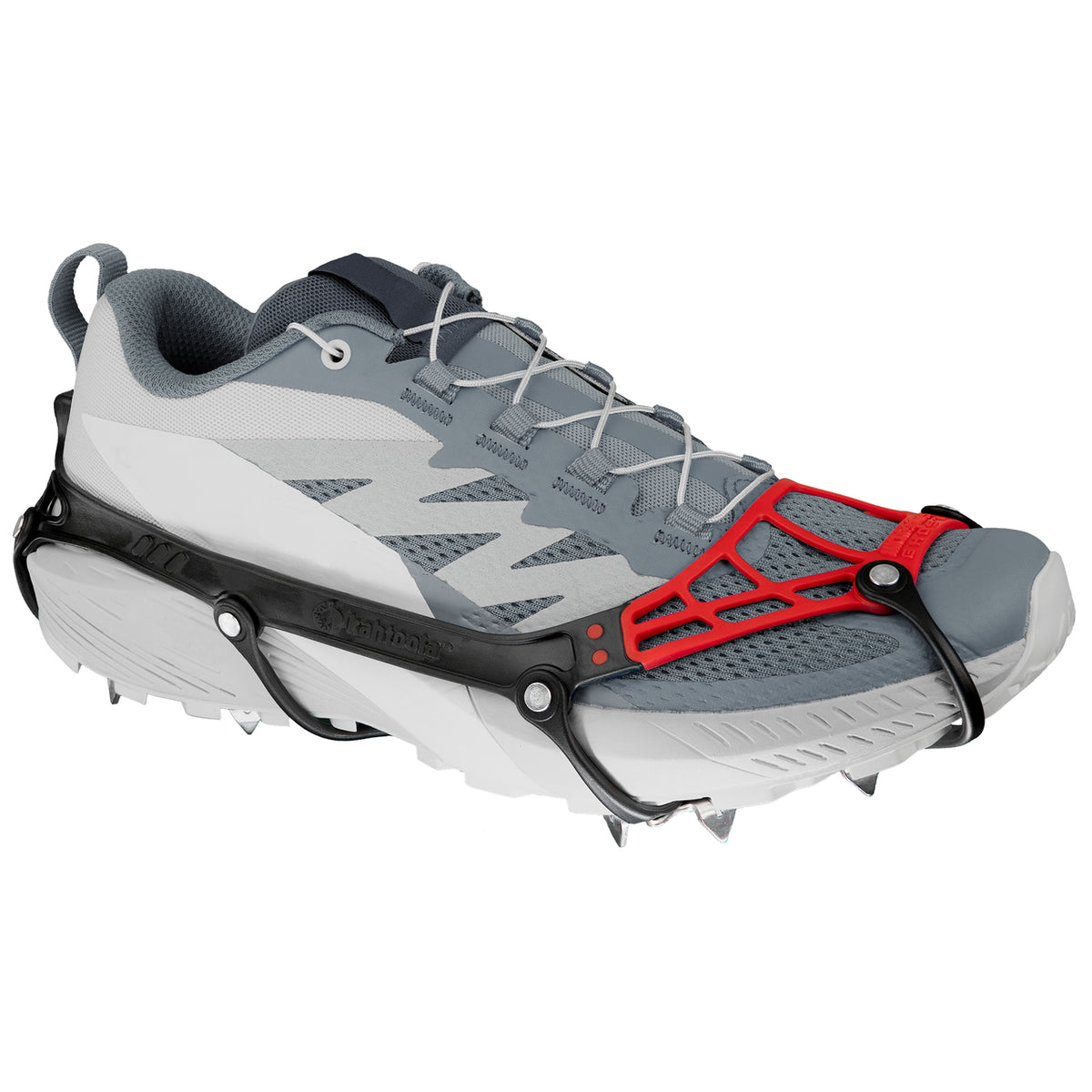 Kahtoola micro ghost spikes in red and black on a running shoe with a white background