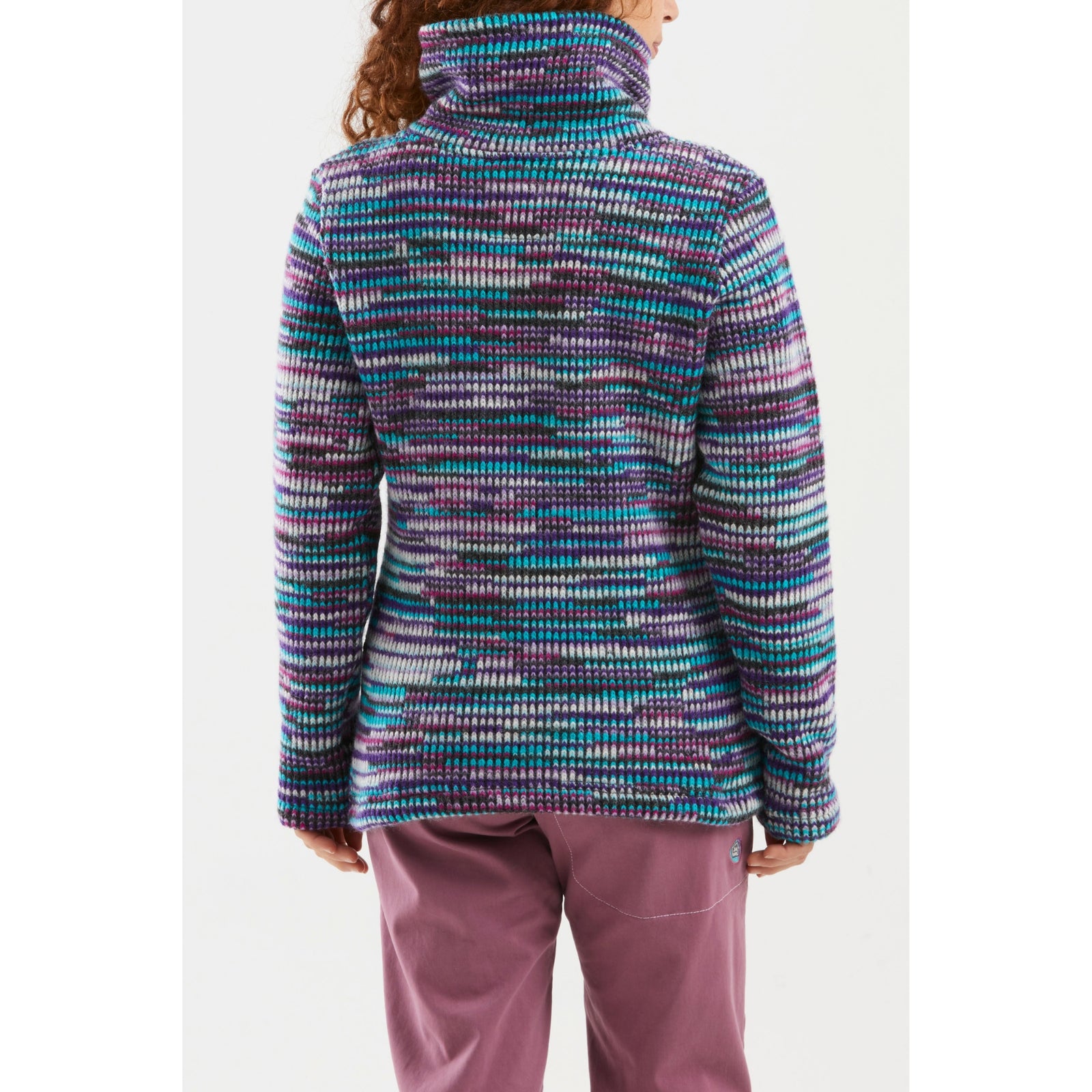 Person wearing a colorful patterned pullover on a white background