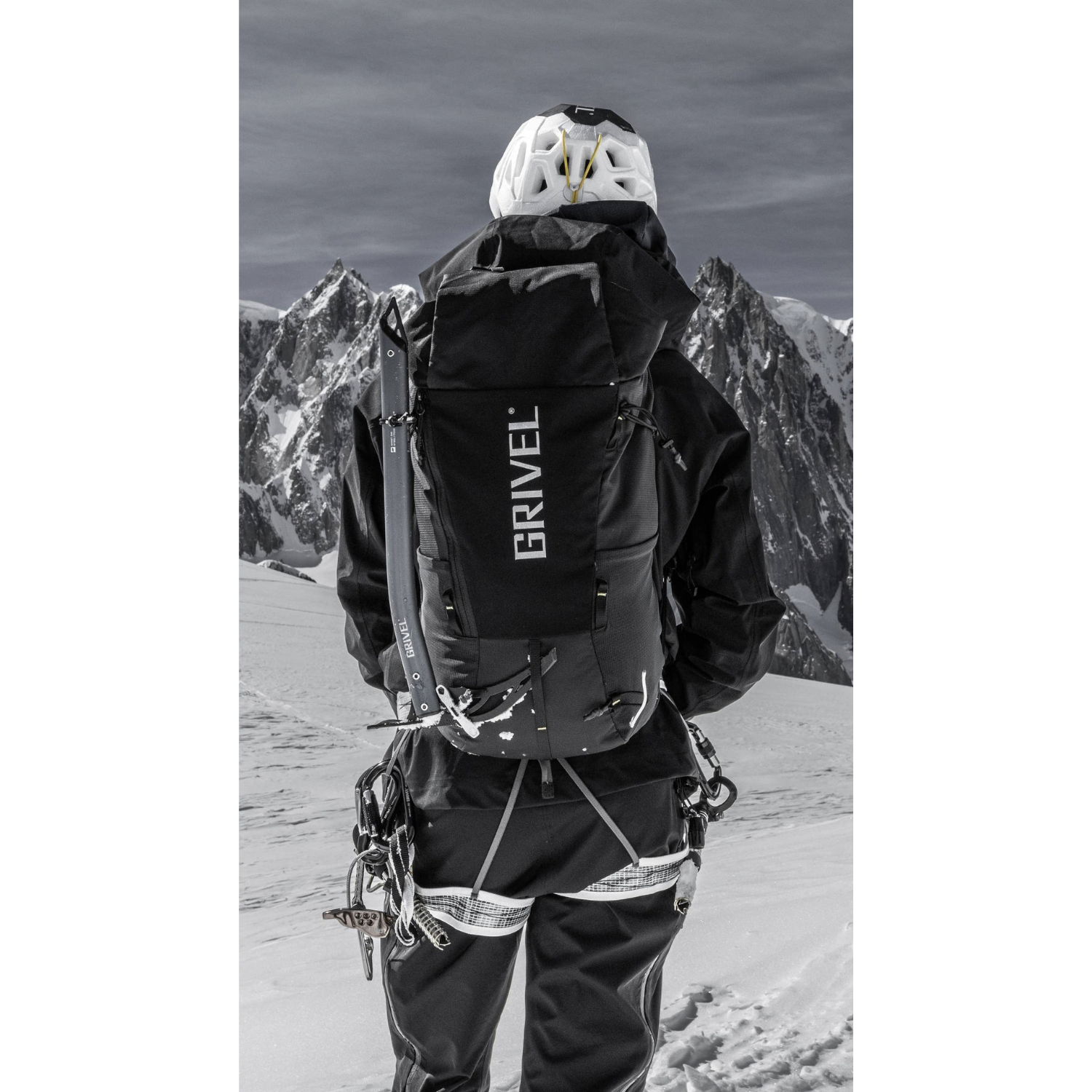 A black Grivel outdoor backpack with a large vertical white GRIVEL logo on the front, shown against a plain white background.