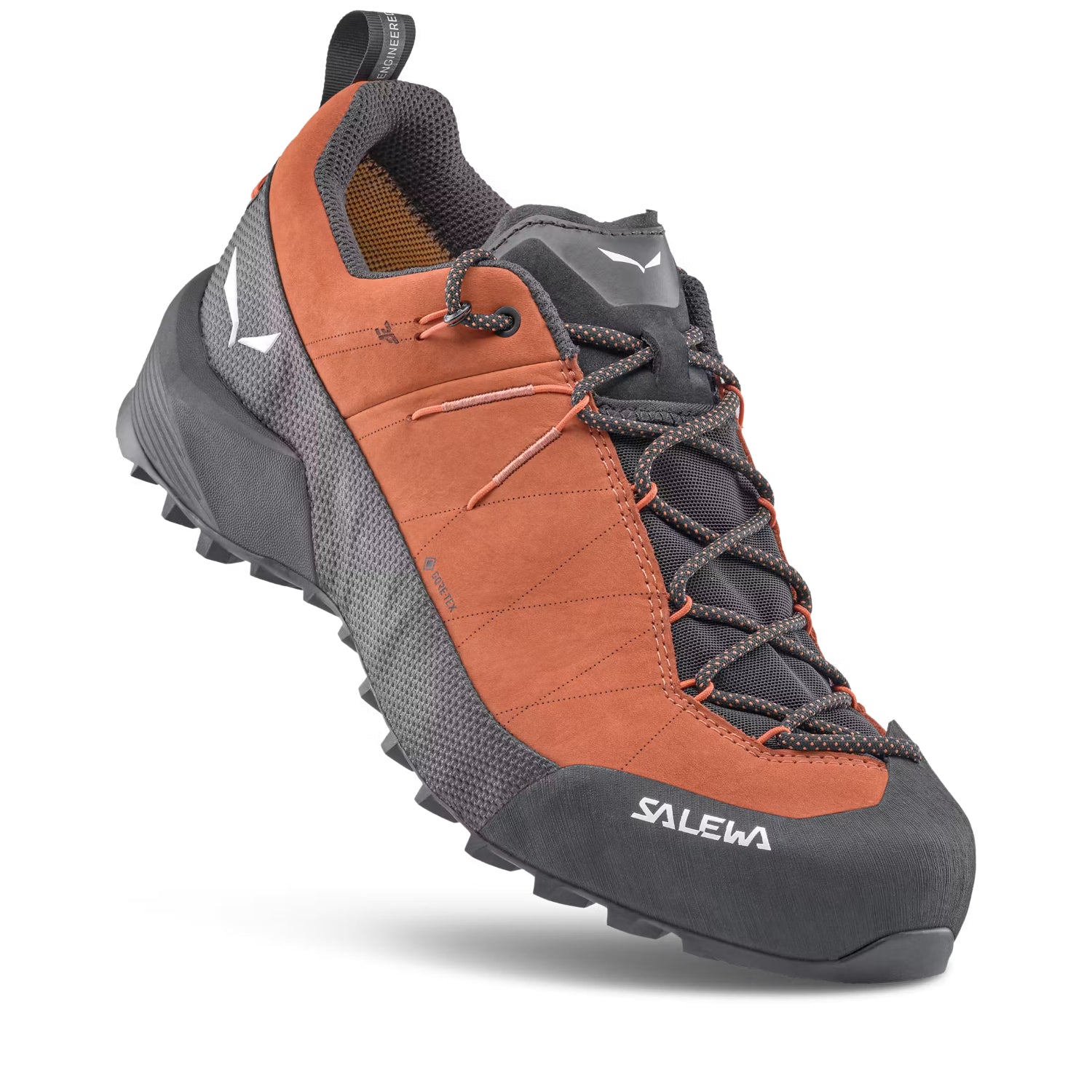 A single Salewa hiking shoe shown at a three-quarter angle on a clean white background. The shoe features a terracotta orange suede upper, dark gray mesh panels, a dark gray synthetic toe cap, and dark gray laces.