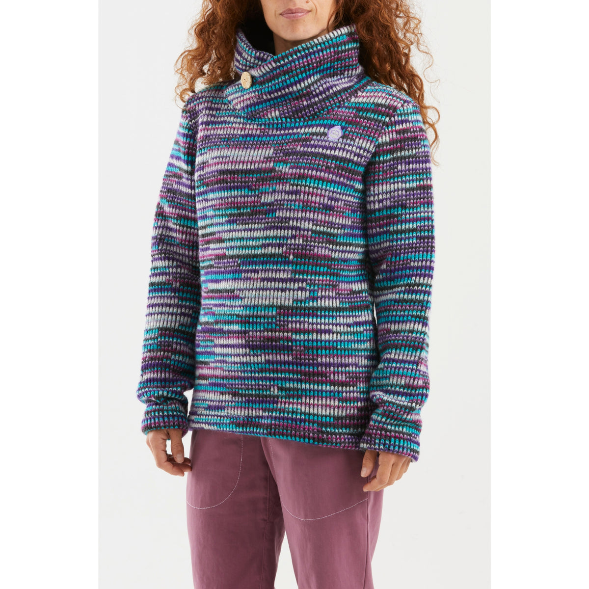 Person wearing a colorful patterned pullover on a white background