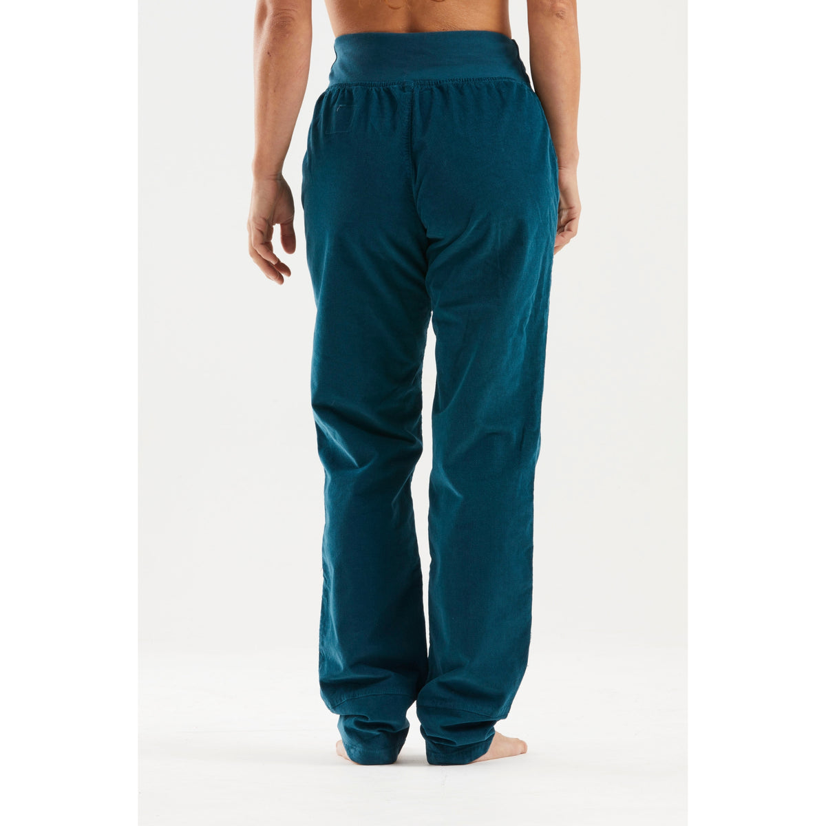Teal sweatpants worn by a person on a white background
