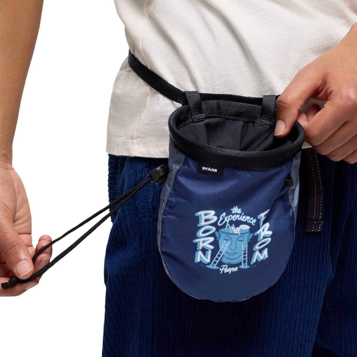 Blue chalk bag with branding held by a person on a white background