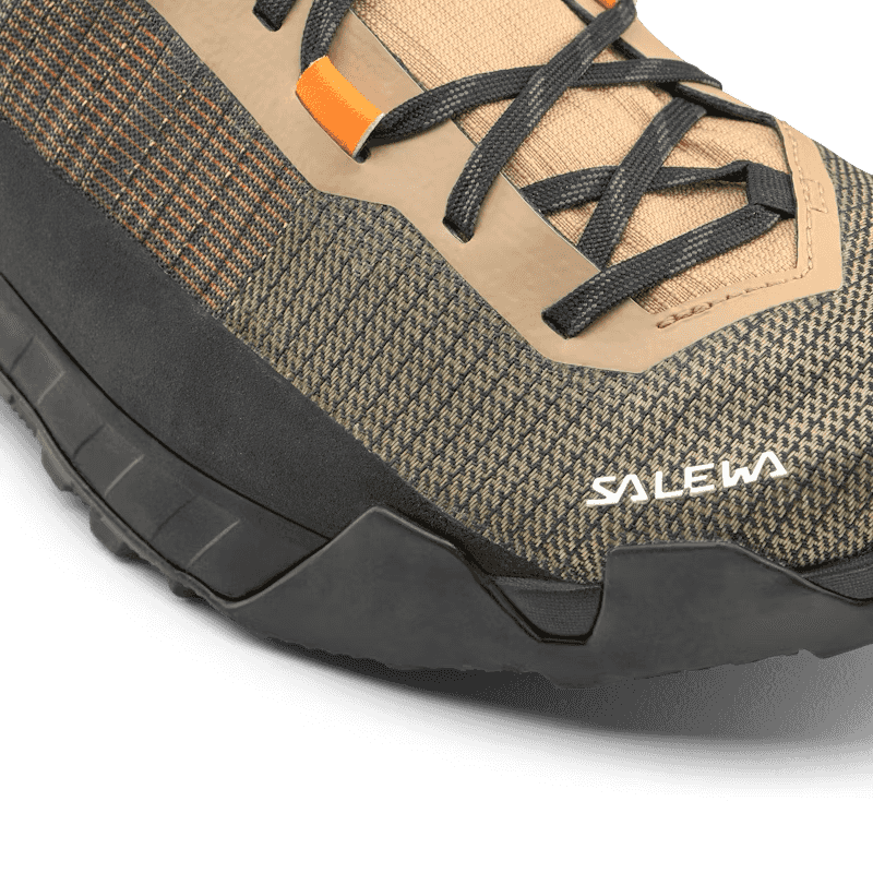 Close-up of a beige and brown hiking boot with black sole and Salewa branding.