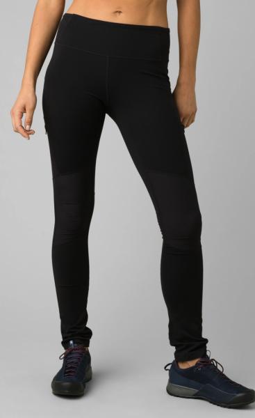 Person wearing black leggings on a gray background