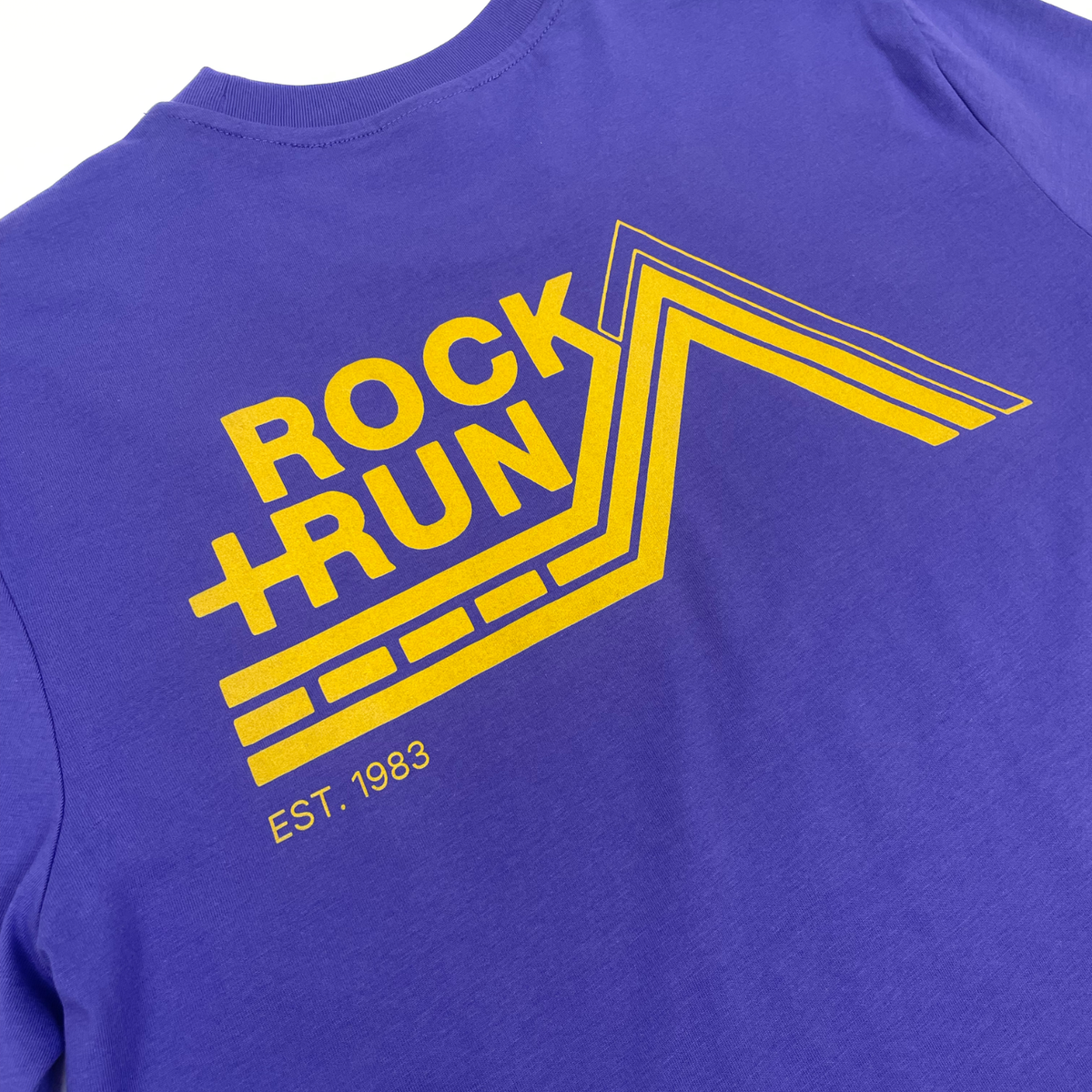 Blue t-shirt with yellow 'Rock Run' logo and 'EST. 1983' text on a white background