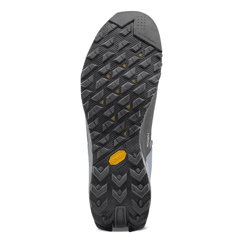 Close-up of a shoe sole with tread pattern and brand logo on a clear background