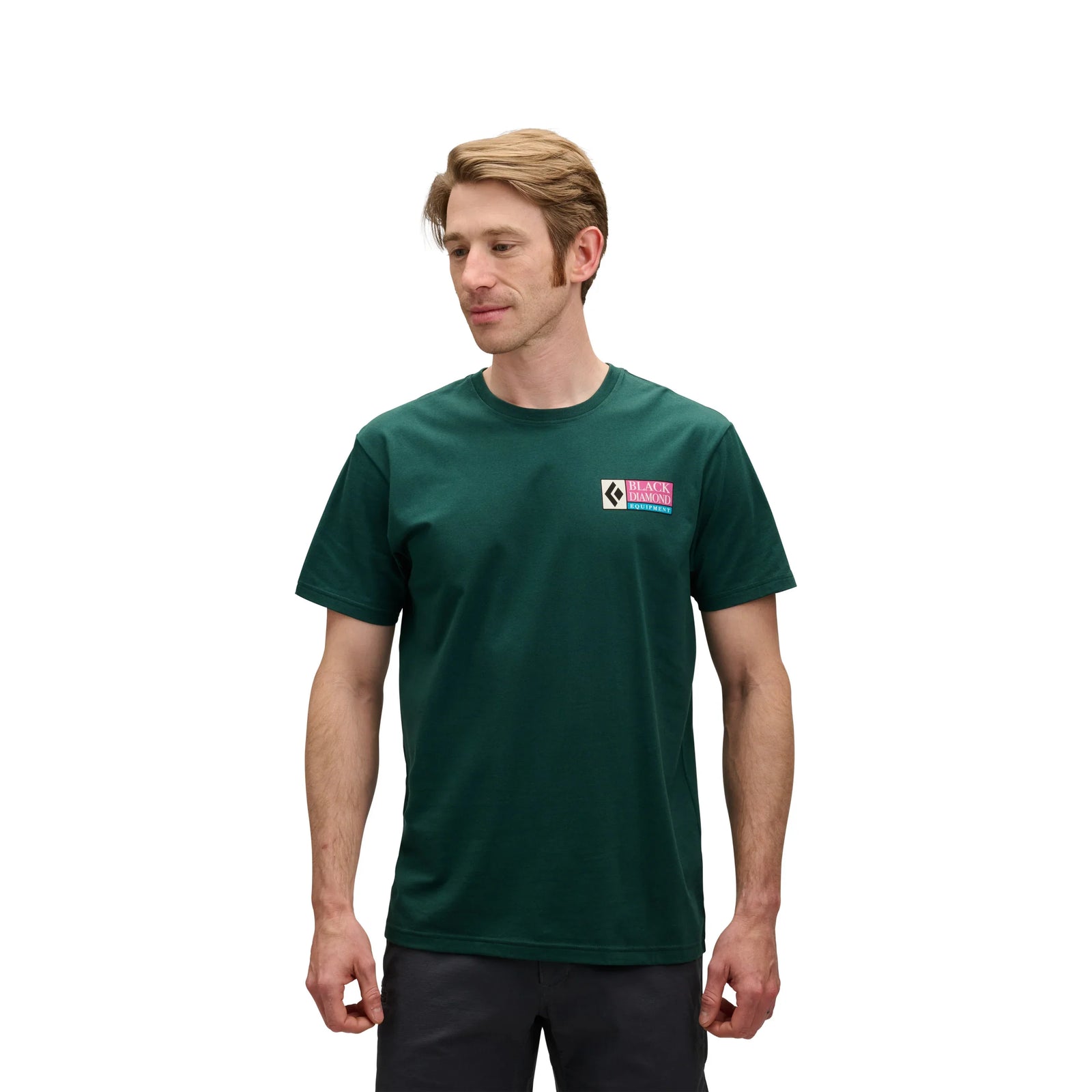 Man wearing a green t-shirt with a logo on a white background