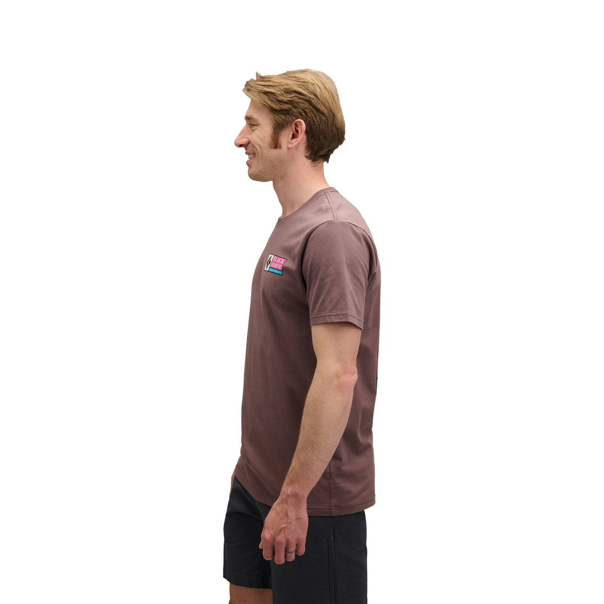 Man wearing a brown t-shirt with a logo on a white background