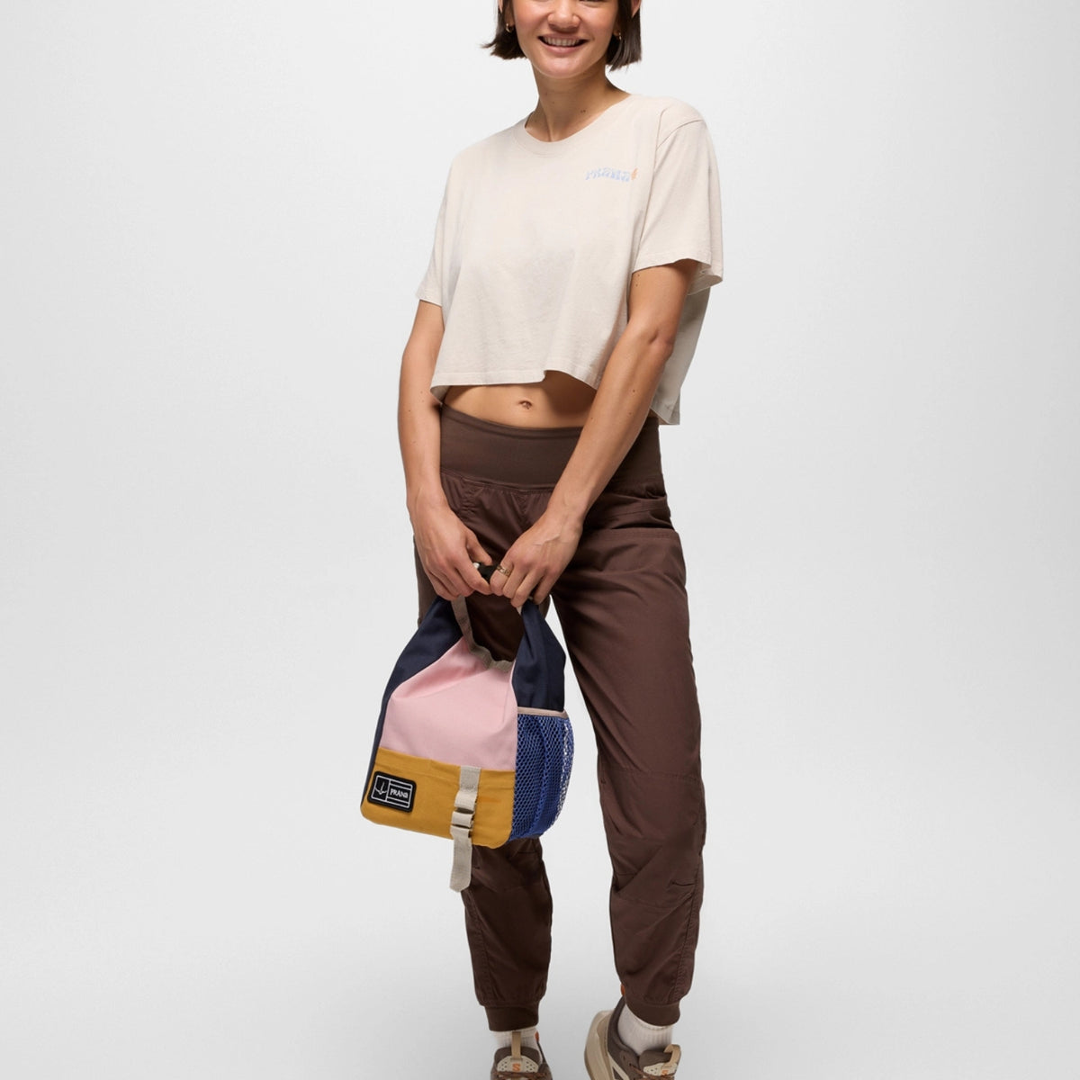 Person holding a colorful bag against a white background