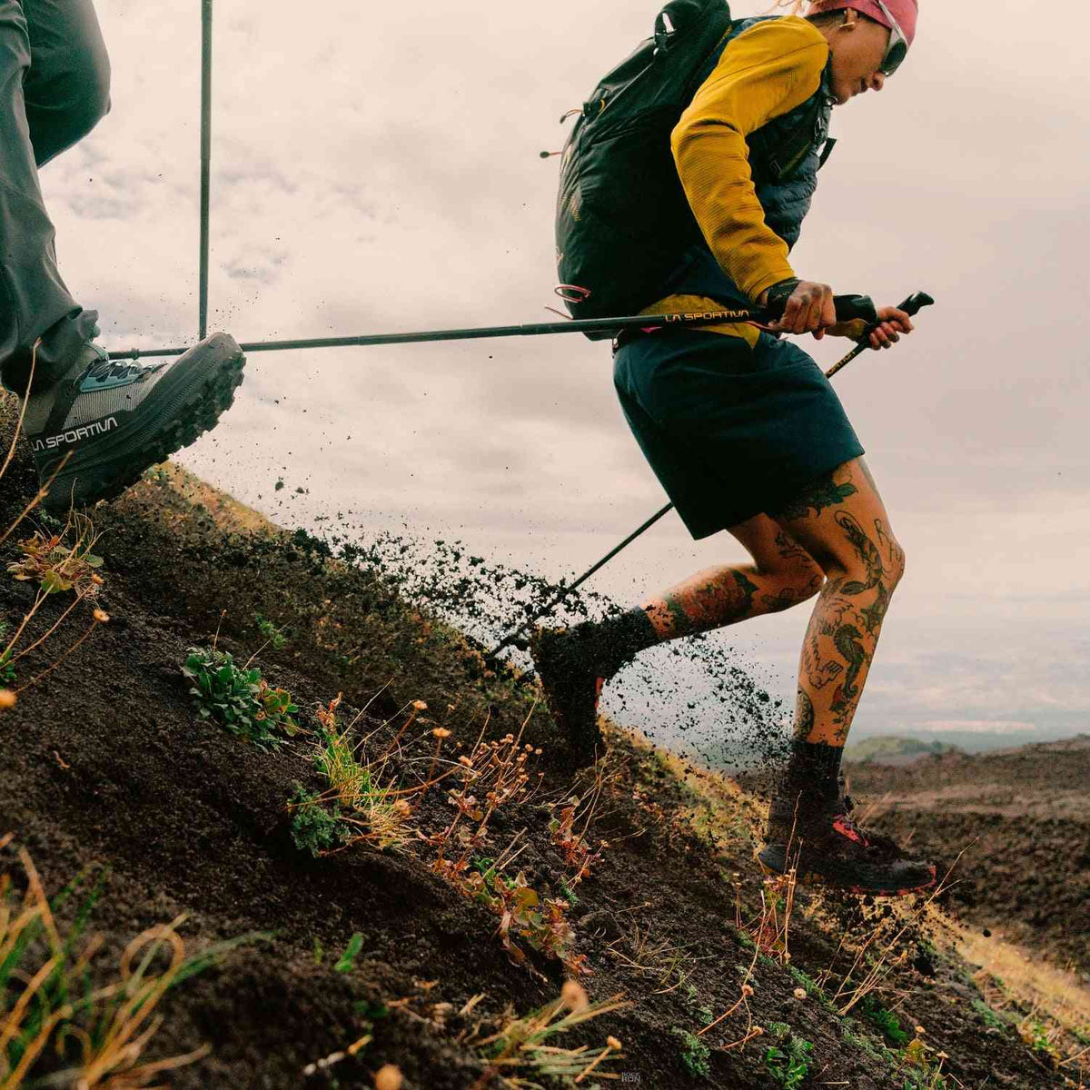 La Sportiva Prodigio Hike GTX - Men's Fast Boots in action on a steep, muddy trail, showcasing grip and agility for fast hiking performance.