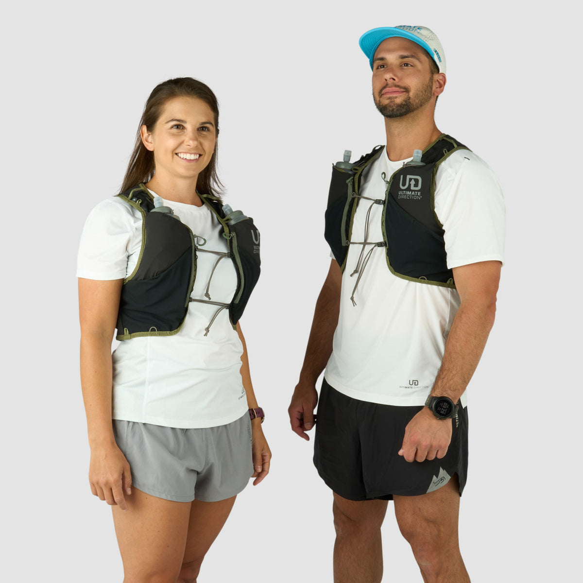 Two people wearing athletic vests and shorts on a white background