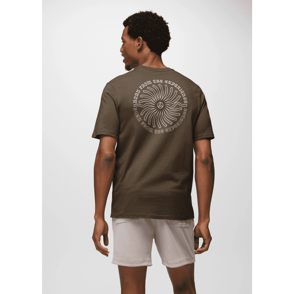 Rear view of model in Prana Lands Beginning T-Shirt displaying large graphic and sustainable fashion appeal.