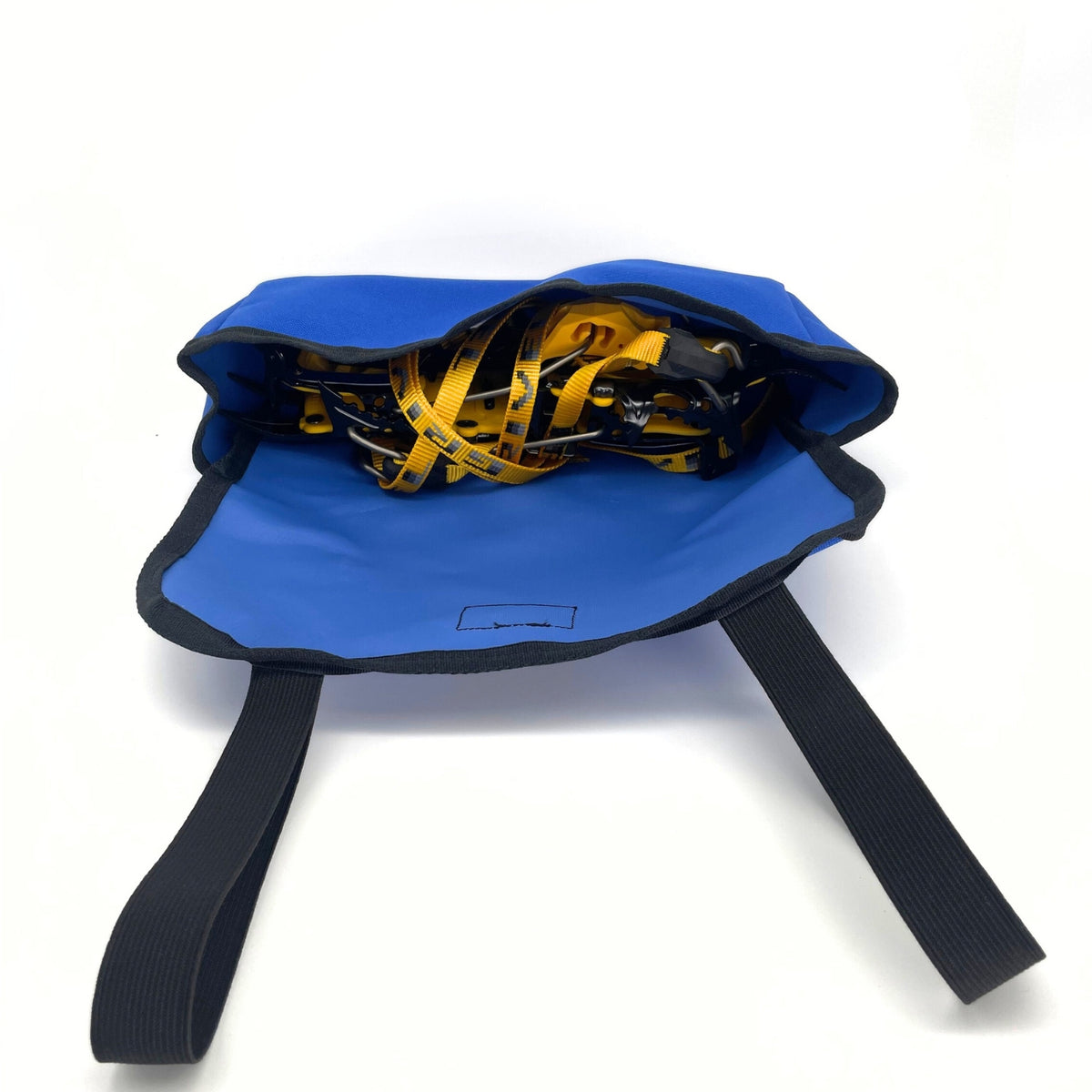 Blue bag with black straps containing yellow and black tape on a white background