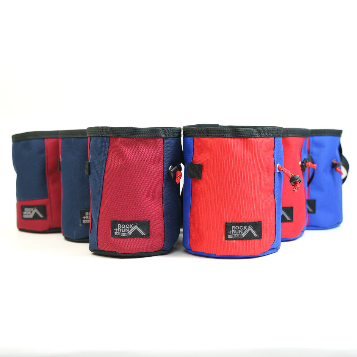 Set of red, blue, and black chalk bags with 'Rock N Run' branding on a white background.