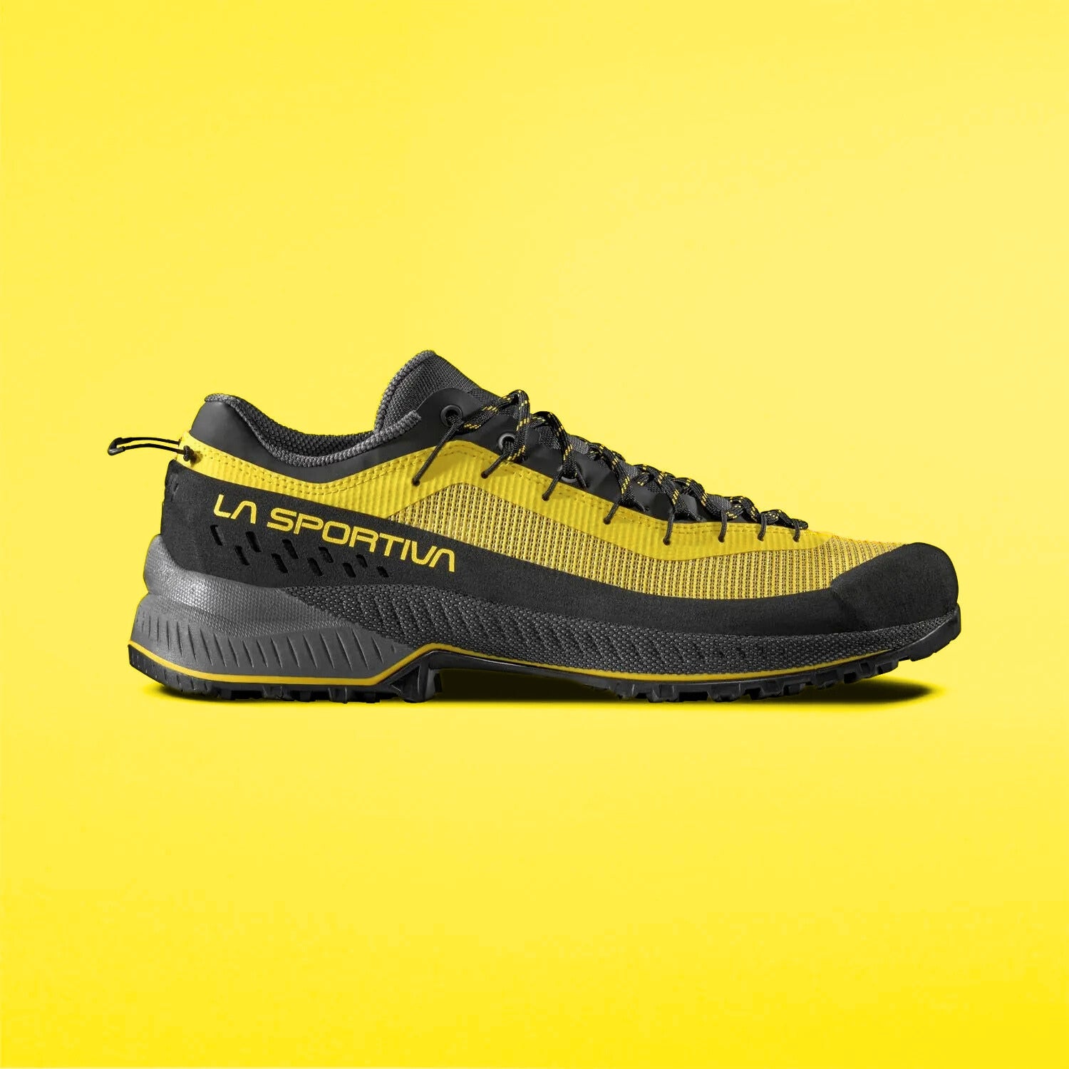 yellow and black approach shoes on a yellow background