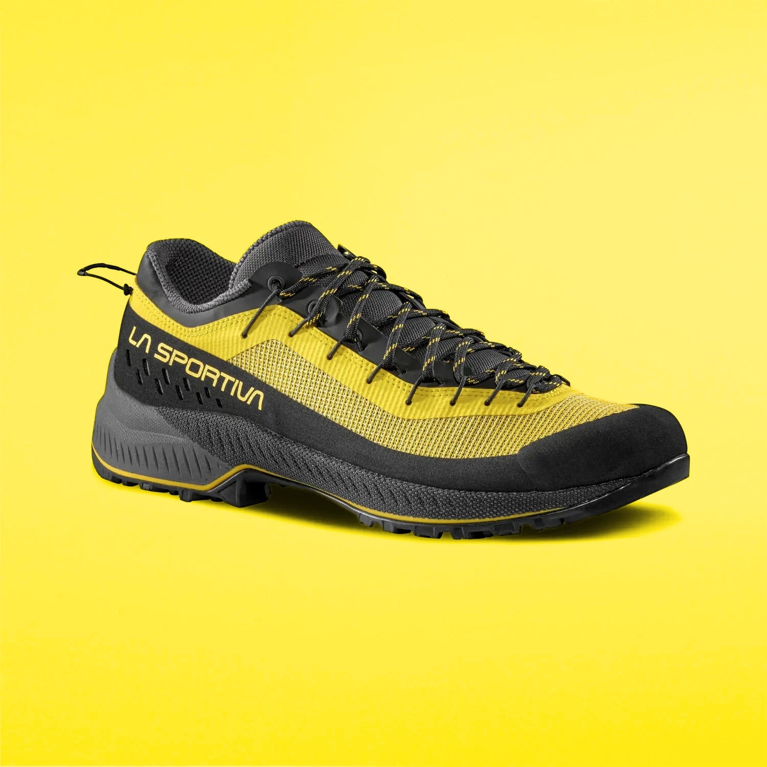 yellow and black approach shoes on a yellow background