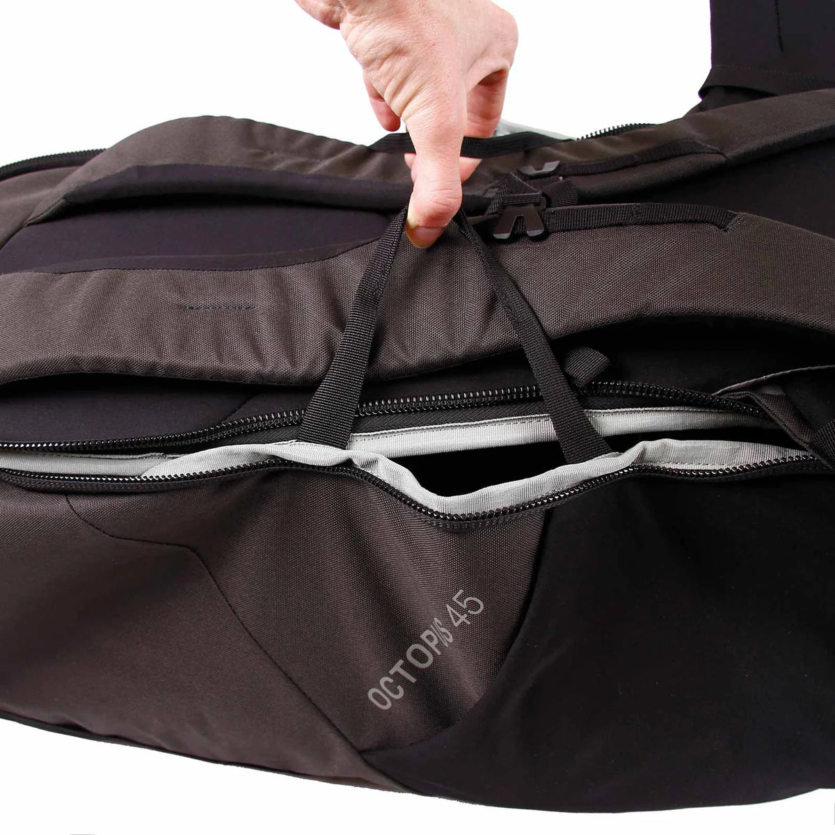 Top zipper access and internal strap system of Blue Ice Octopus 45L rucksack, offering secure and easy gear organization.