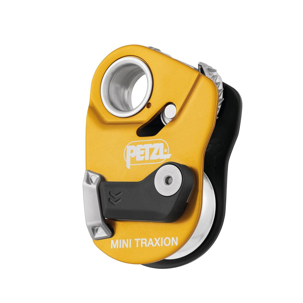 Yellow PETZL Mini Traxion pulley system on a white background