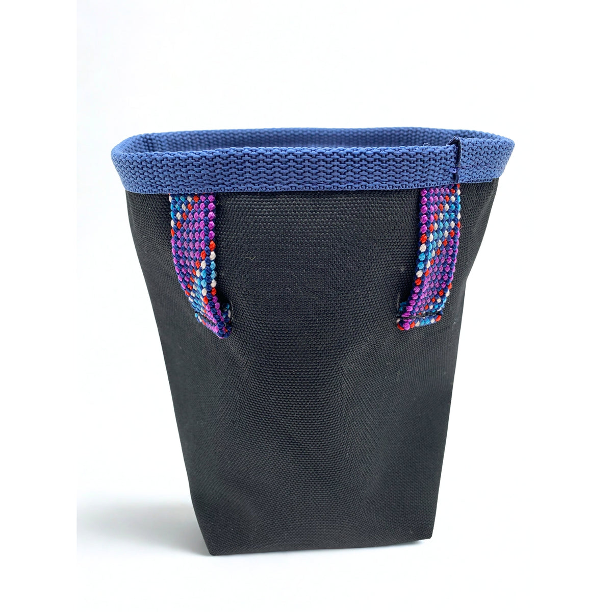 Black fabric basket with blue woven lid and colorful handles on a white background