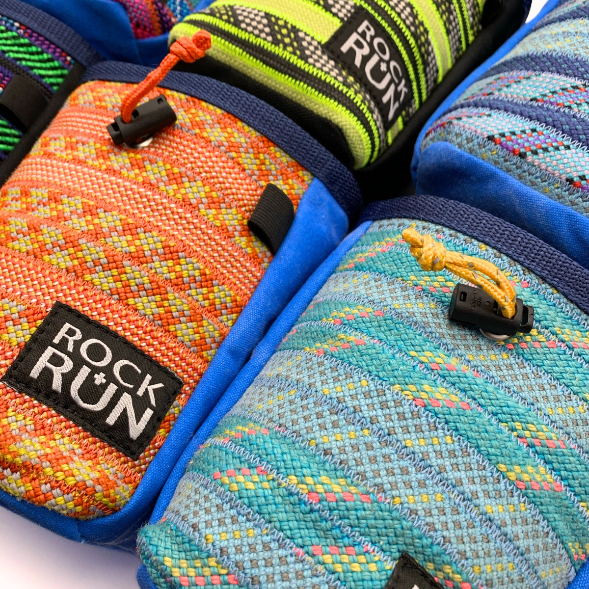 Colorful woven gloves with 'Rock Run' branding on a white background