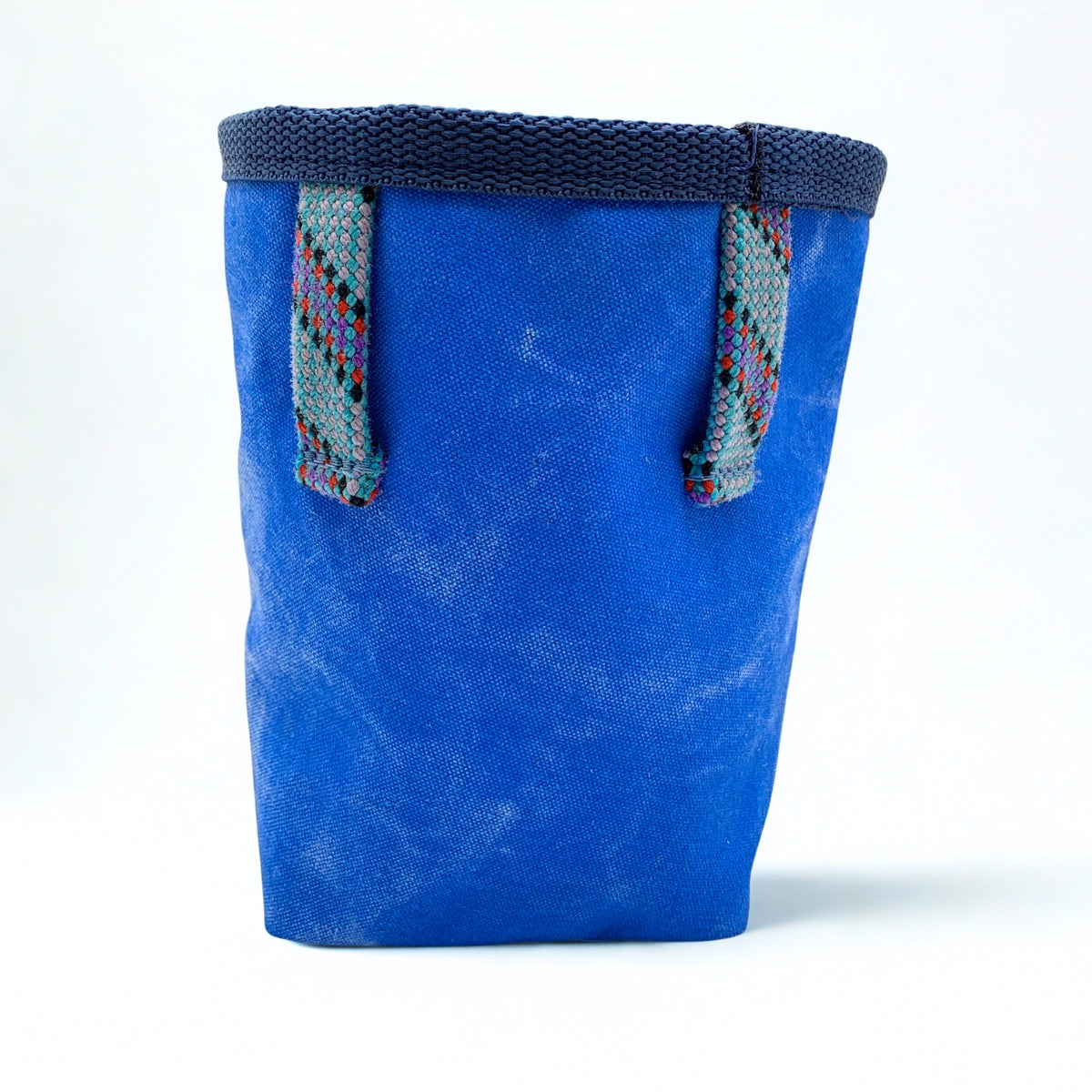Blue chalk bag with textured surface and colorful straps on a white background