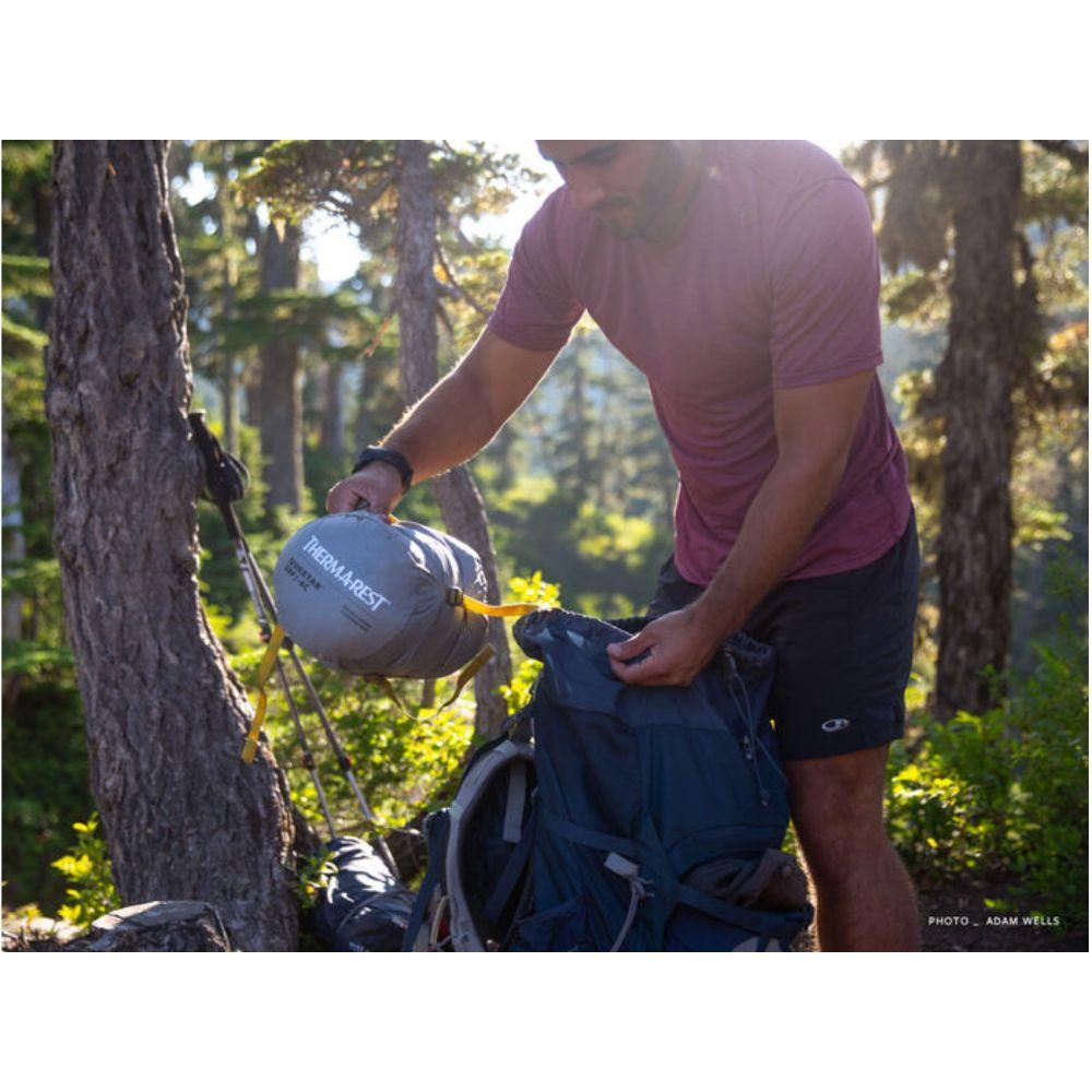 person holding packed up Thermarest Questar 20F/-6C