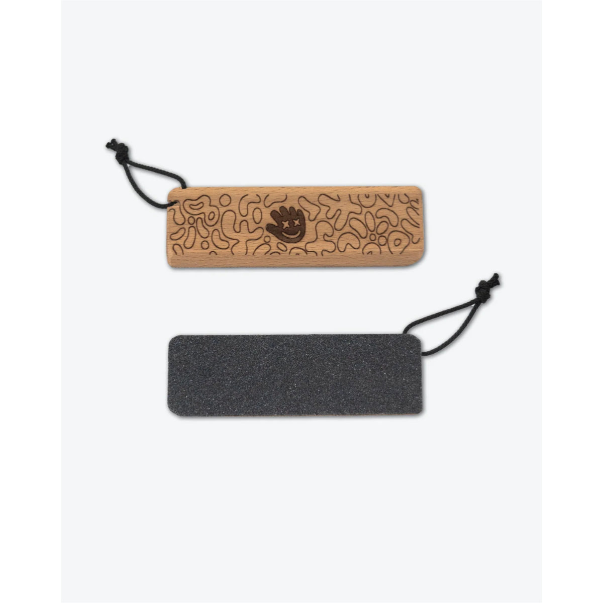 Two rectangular accessory pieces with black hanging cords, shown on a light gray background. The top piece is light tan wood with engraved abstract line patterns and a small dark emblem in the center.