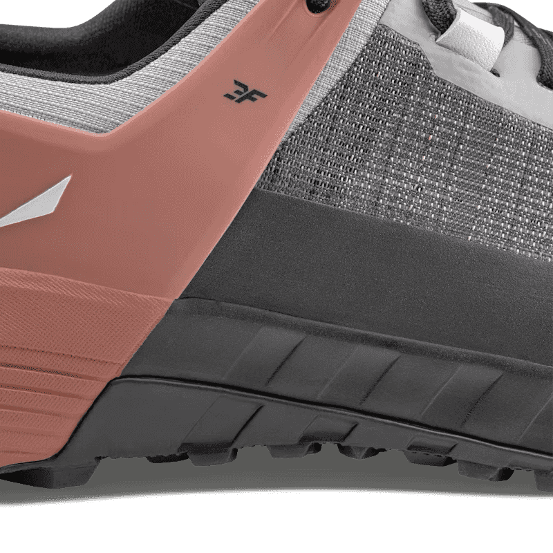 Close-up of a shoe with a focus on the sole and brand logo.