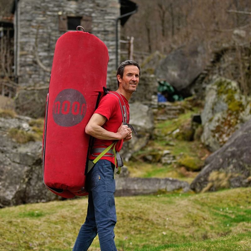 Moon Warrior crash pad in red being carried