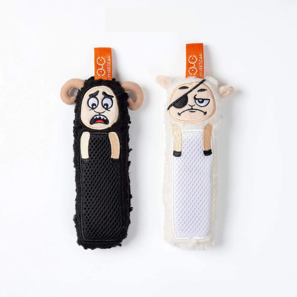Two sheep, shaped deodorisers like a black sheep and a white lamb on a white background