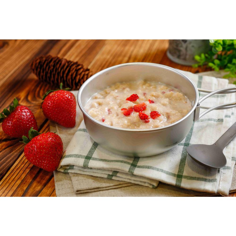 Expedition Foods Porridge with Strawberries shown in a bowl, next to a spoon and fresh ingredients