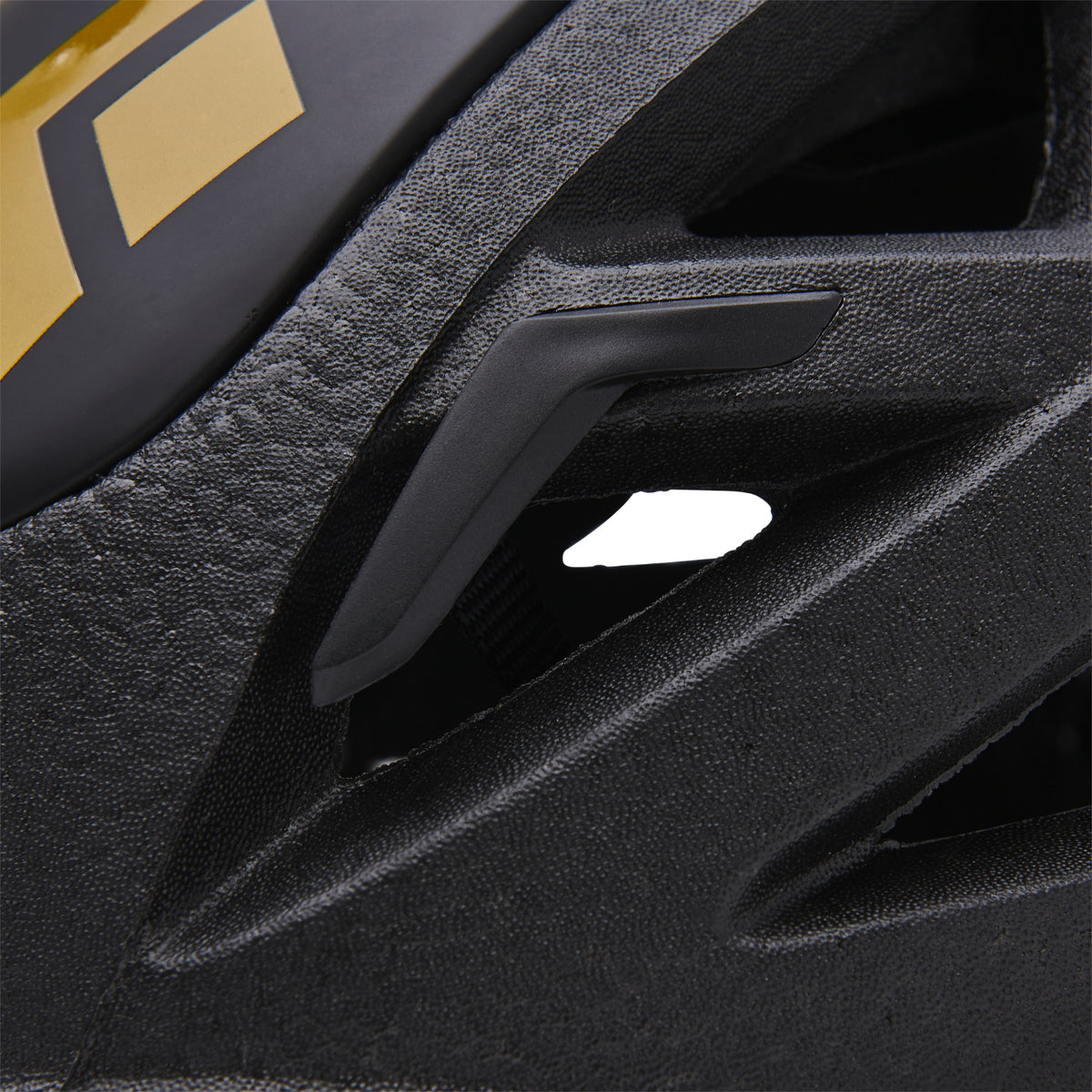 Black Diamond Vapor helmet in black with a gold logo close up of head torch attachment