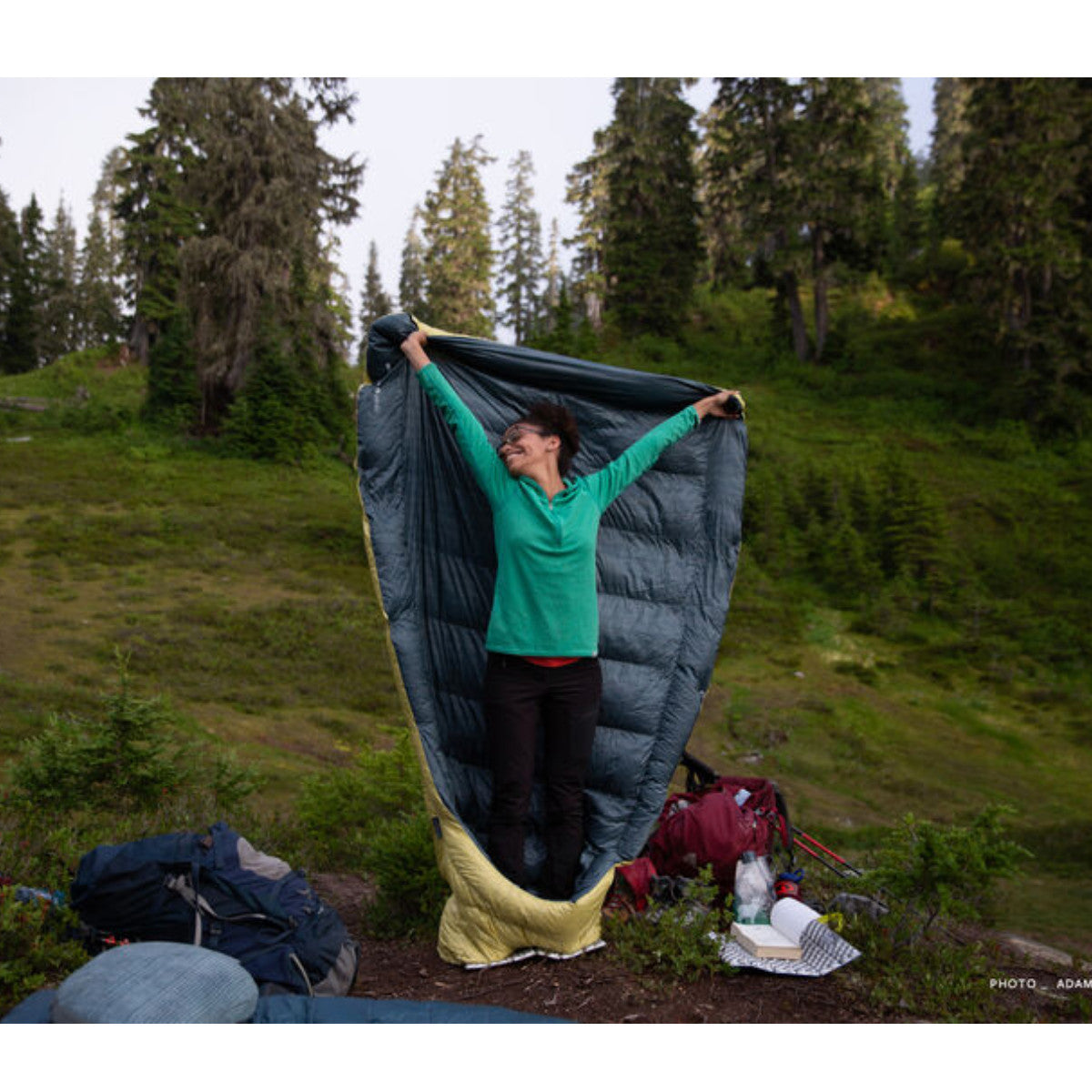 Thermarest Corus 20F/-6C Quilt in golden colour showing person holding it in air